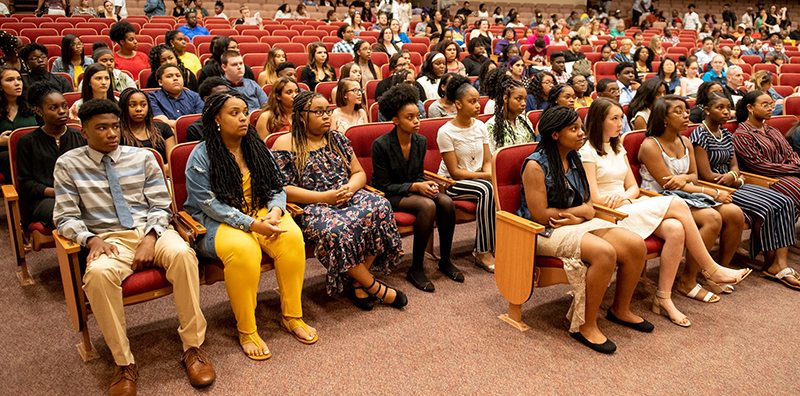 students attending induction in auditorium