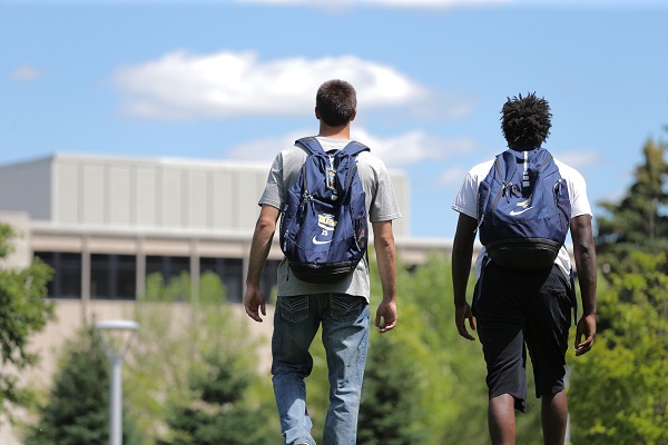 men walking with backpacks