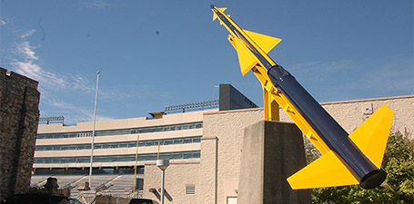 The blue and gold rocket pointing up at the sky